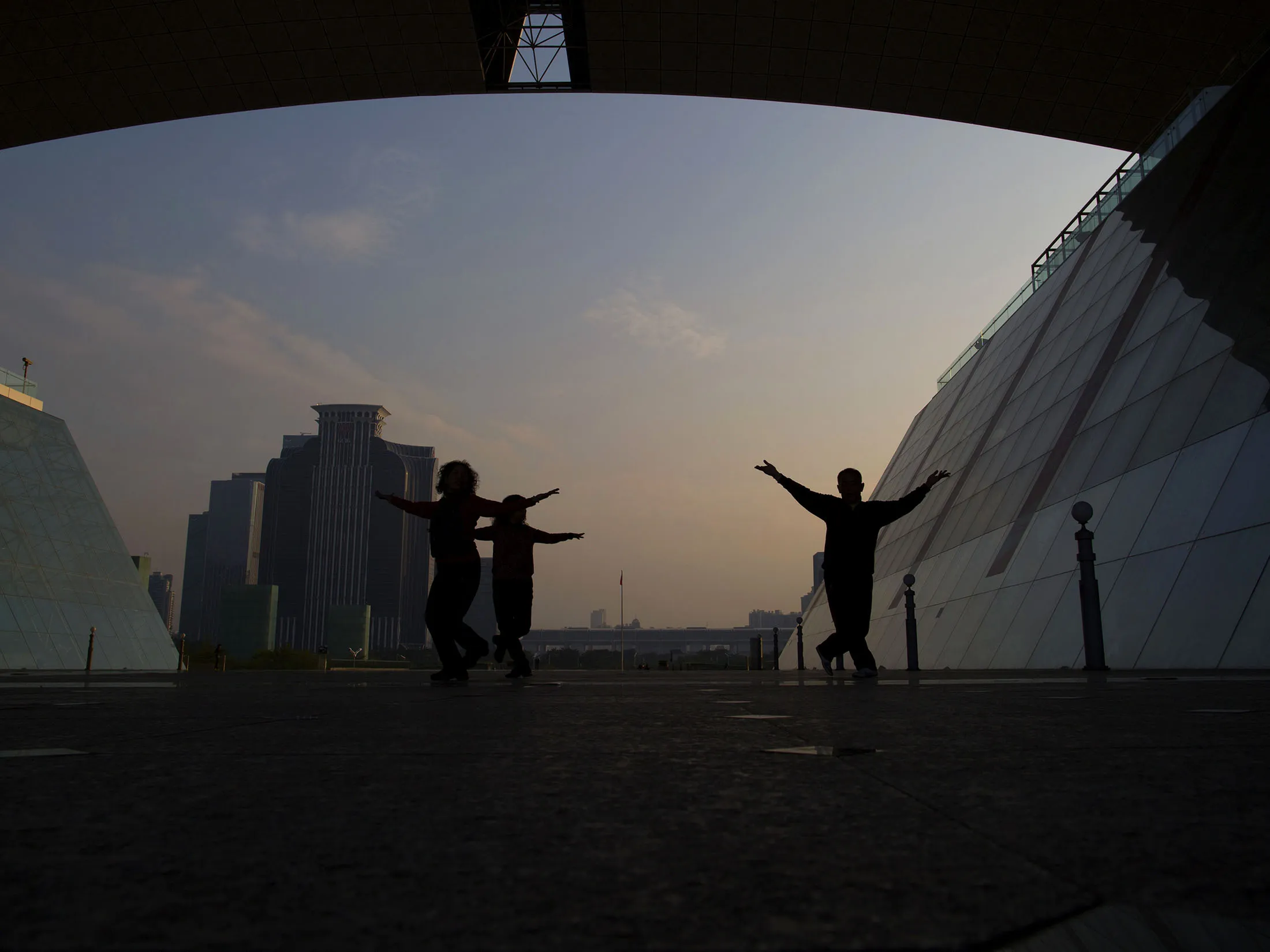 People dance at the Shenzhen Civic Center in Shenzhen.