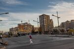 A pedestrian crosses a nearly empty street in Santiago, Chile, on Monday, April 20, 2020. Chile has a system of rolling obligatory quarantines based on a formula combining an area's new cases per capita, the size of its elderly population and access to health care.