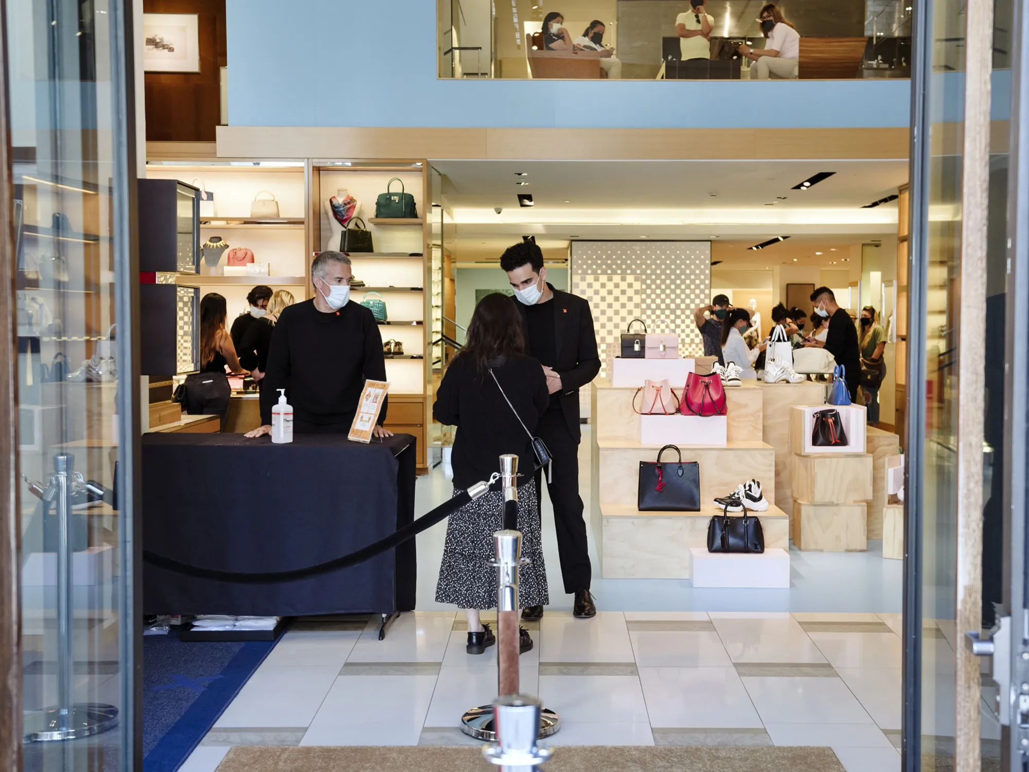 Sales associates greet a customer at a store in San Francisco, California.