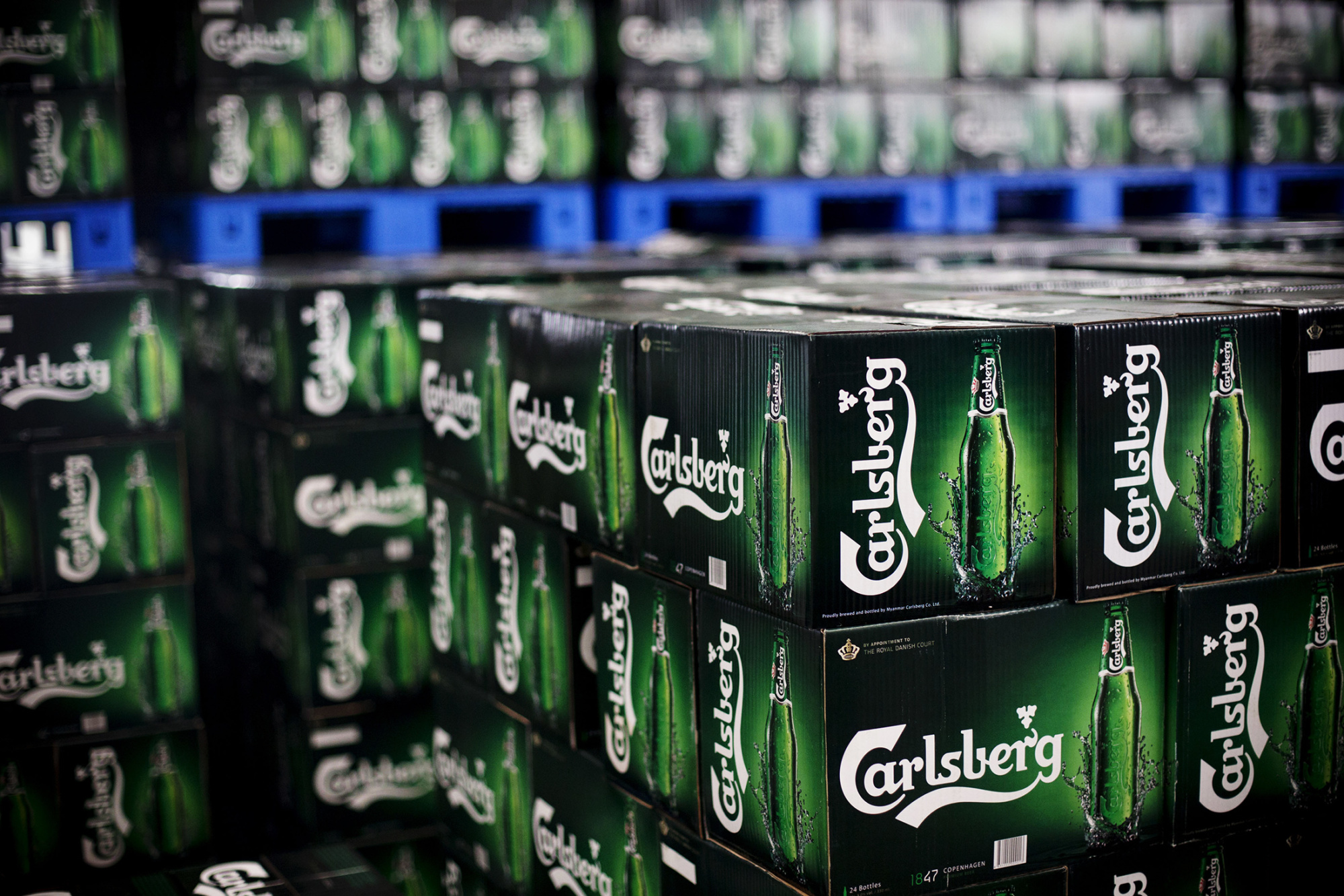 Cases of Carlsberg A/S beer sit in a warehouse on Oct. 7, 2015.
