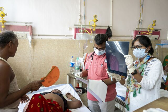 Dr. Kamlesh Kumar and a medical intern go over test results.