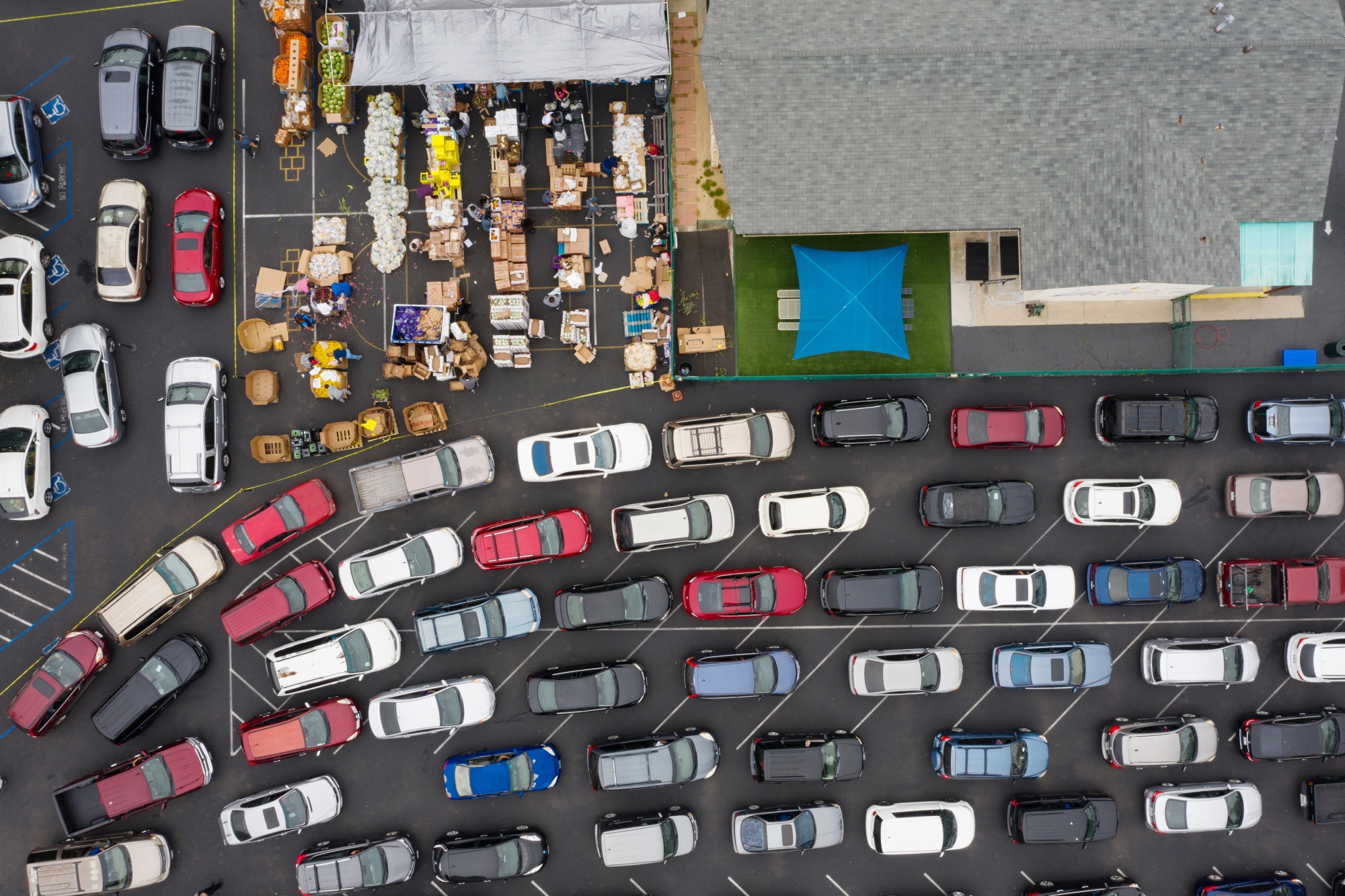 People wait in their vehicles to receive food at a drive-thru food distribution event in Chula Vista, Calif., on&nbsp;May 1, 2020.