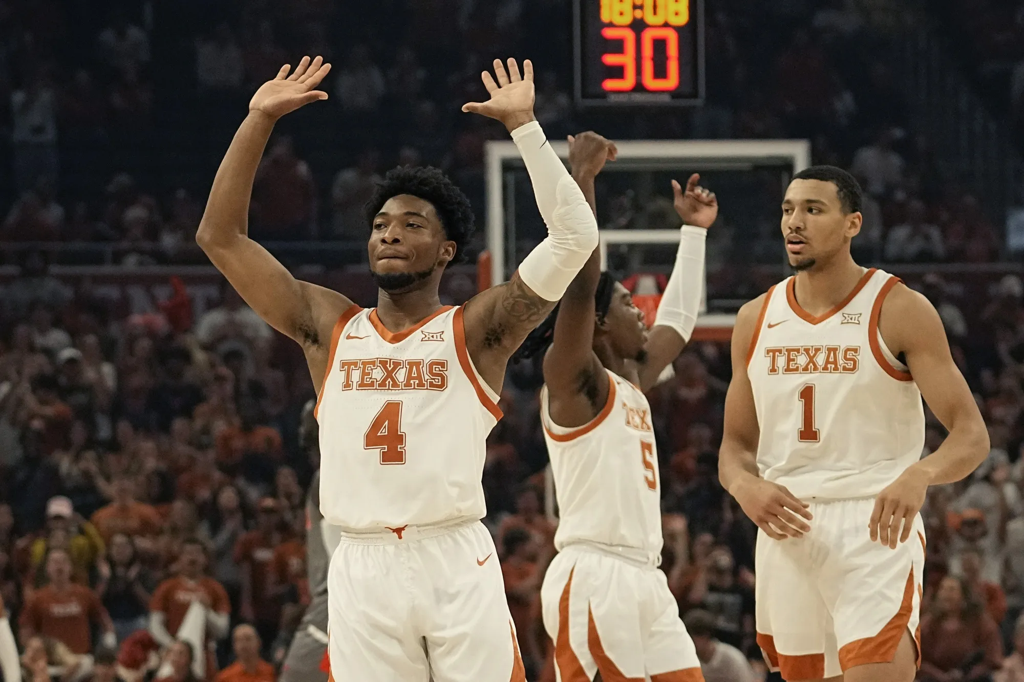 Texas guard Arterio Morris (2) celebrates a score with teammates Marcus Carr (5) and Dylan Disu (1) during the first half of an NCAA college basketball game against Houston Christian, Thursday, Nov. 10, 2022, in Austin, Texas. (AP Photo/Eric Gay)