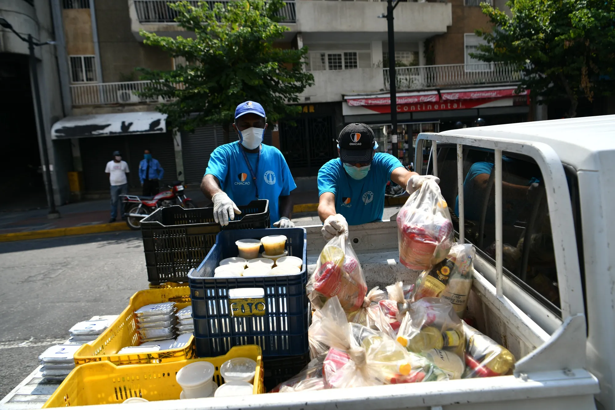 City workers deliver food to residents in Caracas, Venezuela, on April 13.