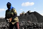 A worker sorts coal near a coal mine in China