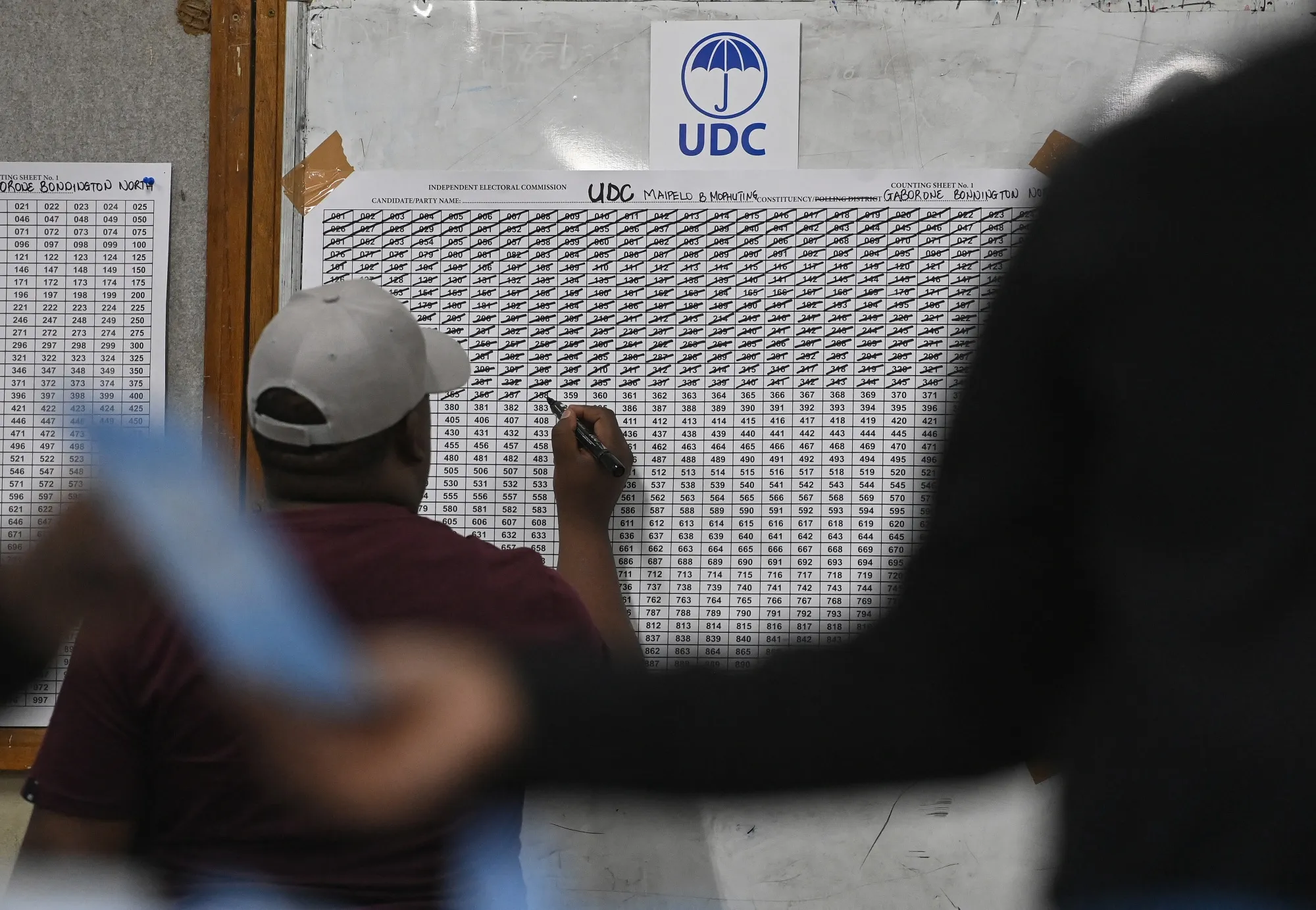 An electoral official marks the tally sheet during the vote count in Gaborone.