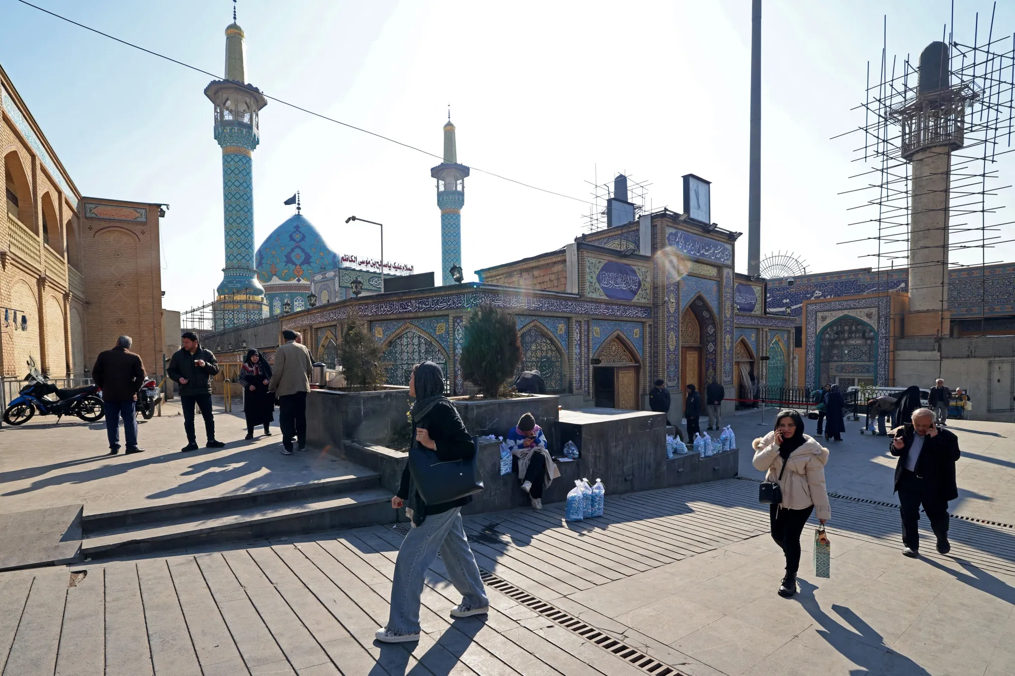 People walk past the Imamzadeh Saleh mosque at Tajrish Square in Tehran on Jan. 28.