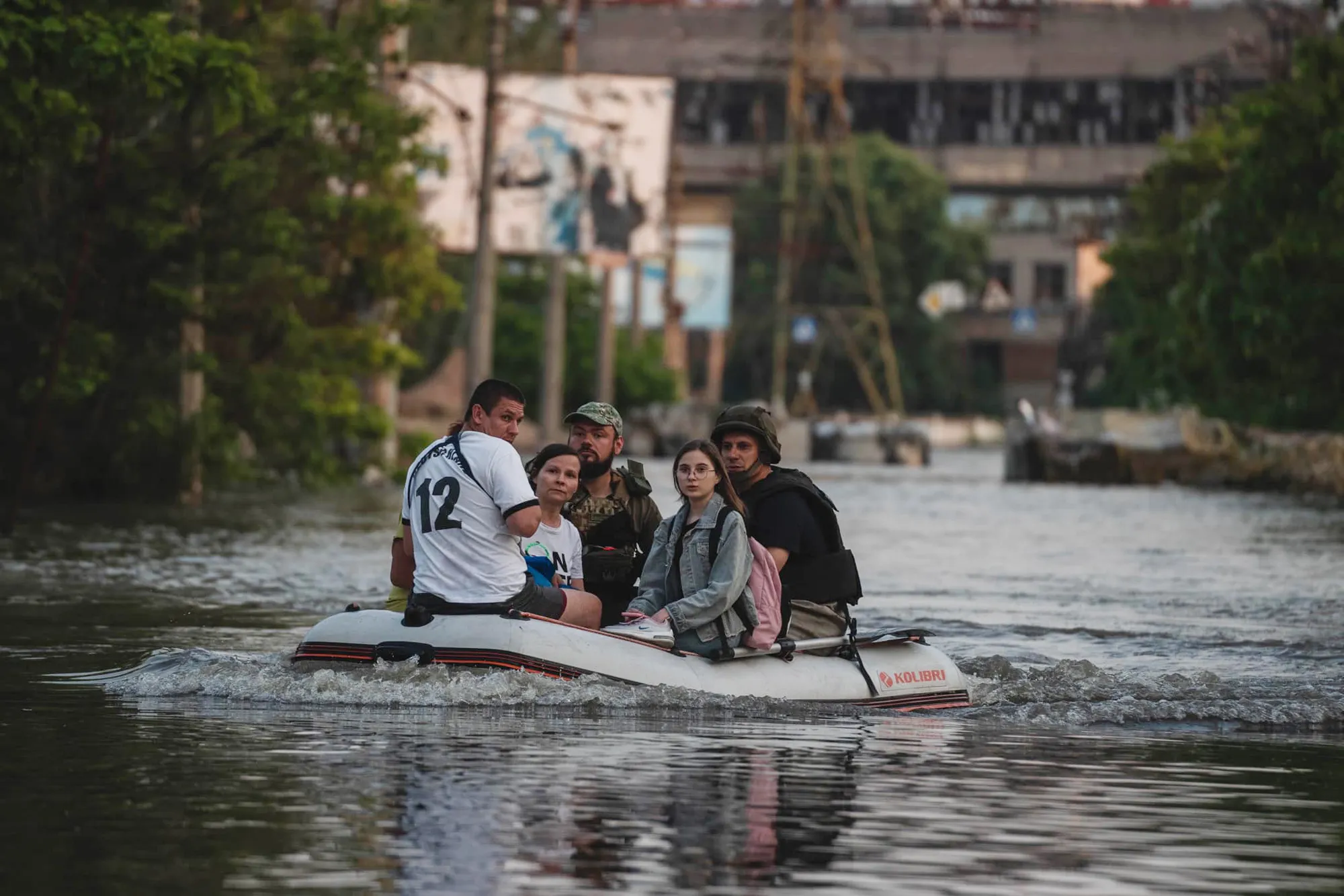 Rescue workers transport residents across floodwaters in Kherson, Ukraine, on June 7.