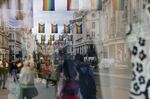 Pedestrians pass shops along Regent Street in central London.