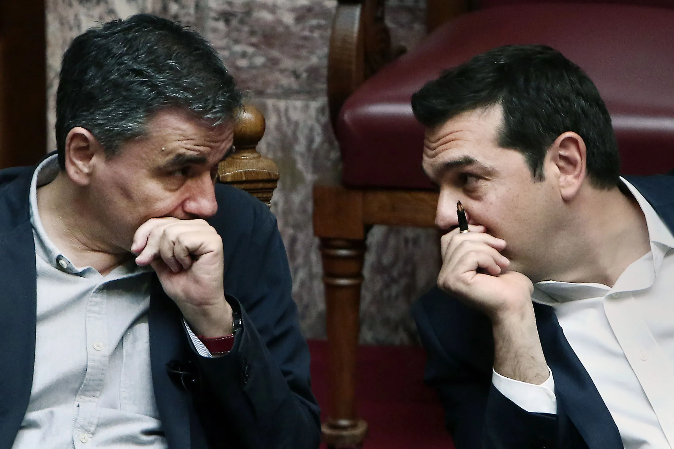 Greek Prime Minister Alexis Tsipras speaks with Greek Finance Minister Euclid Tsakalotos.
