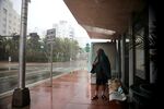 A homeless man takes shelter at a bus stop in Miami Beach shortly before Hurricane Irma. 