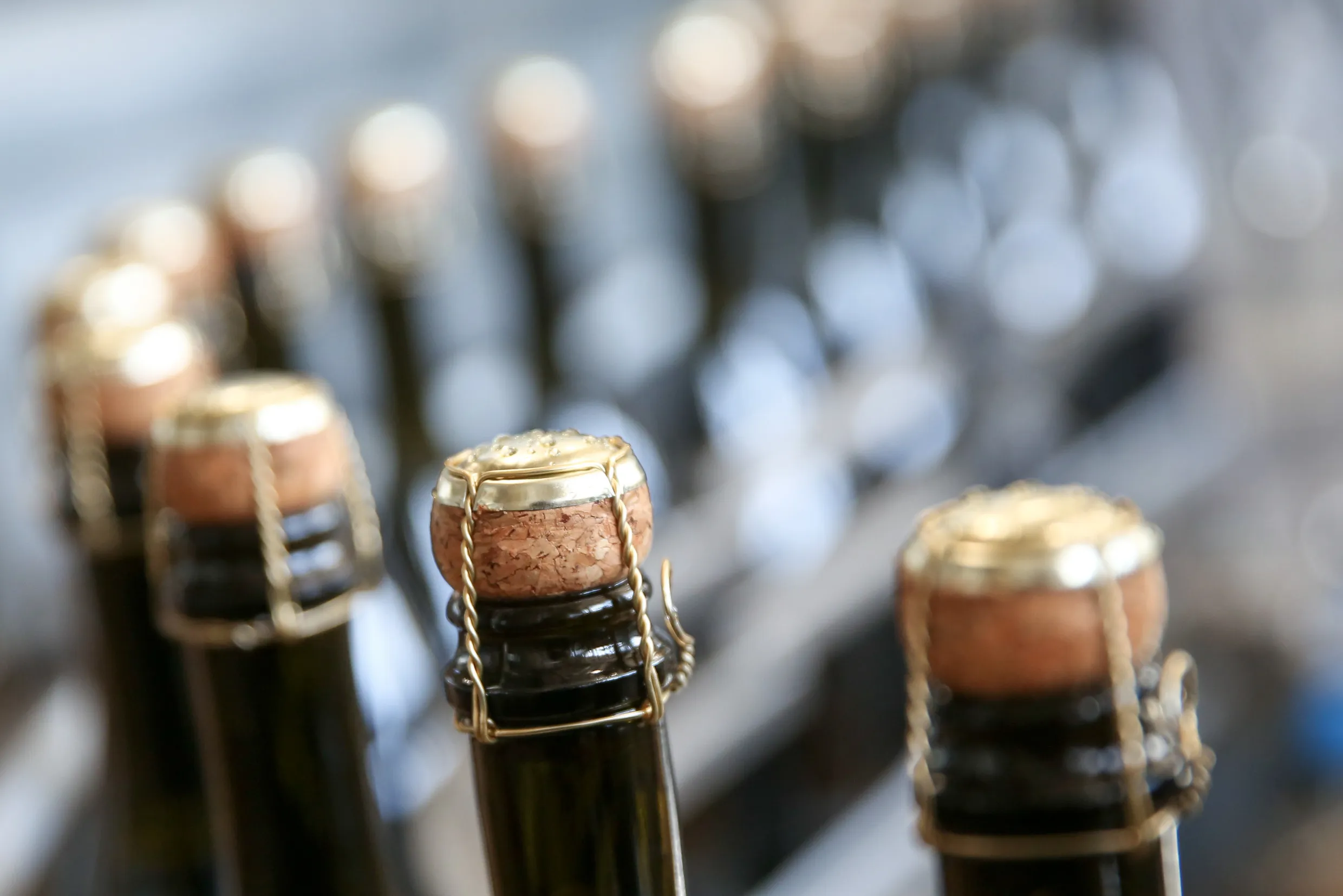Bottles of Prosecco wine along a conveyor belt at a&nbsp;winery.