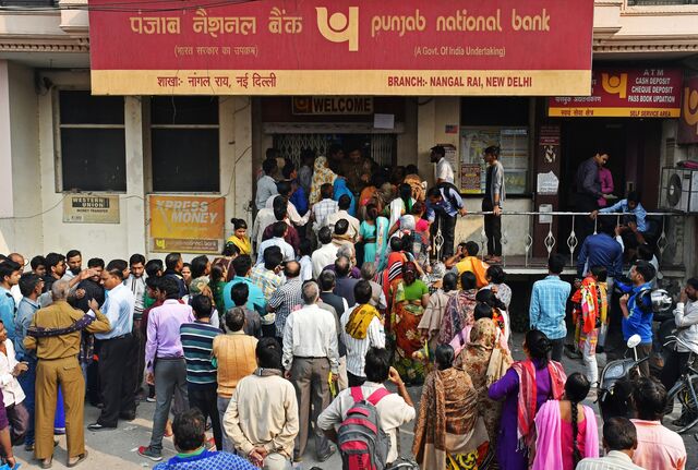 People queuing outside a bank in New Delhi to exchange old currency notes for new ones, 2016.