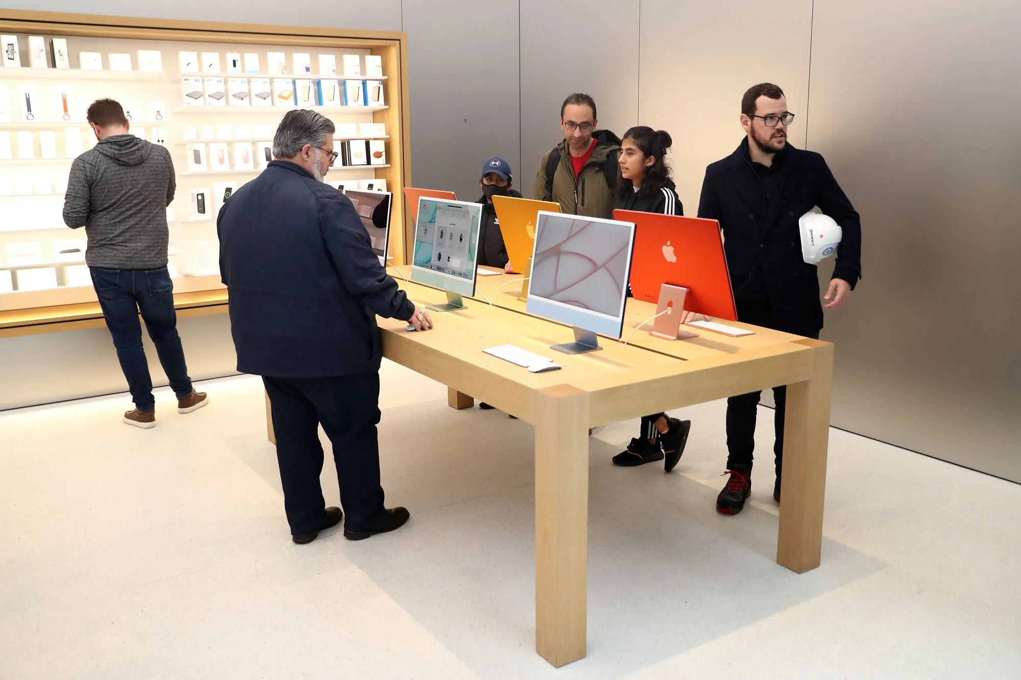 An Apple retail store with M1 iMacs.