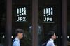 Pedestrians walk past the entrance of the Tokyo Stock Exchange.