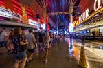 People navigate the rainy walkways as some power is out at the Fremont Street Experience as a powerful storm moves through the area on Thursday, July 28, 2022, in Las Vegas. (L.E. Baskow/Las Vegas Review-Journal via AP)