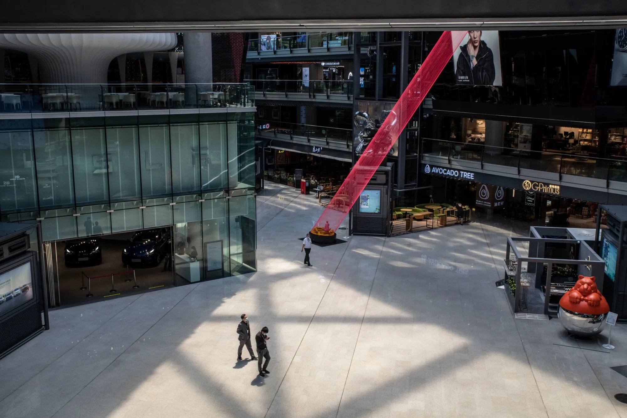 Shoppers walk through a shopping mall in Beijing, on May 30.
