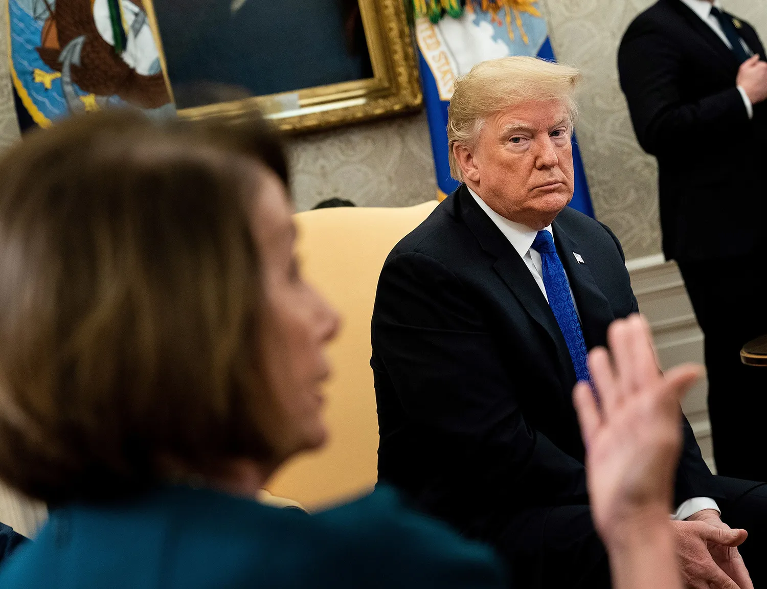 Trump listens to Pelosi during a meeting at the White House on Dec.&nbsp;11, 2018.