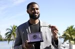 Miami Marlins pitcher Sandy Alcantara, the 2022 National League Cy Young winner, holds the key to the City of Miami awarded to him by Miami Mayor Francis Suarez, at Miami City Hall, Tuesday, Jan. 10, 2023, in Miami. (AP Photo/Lynne Sladky)