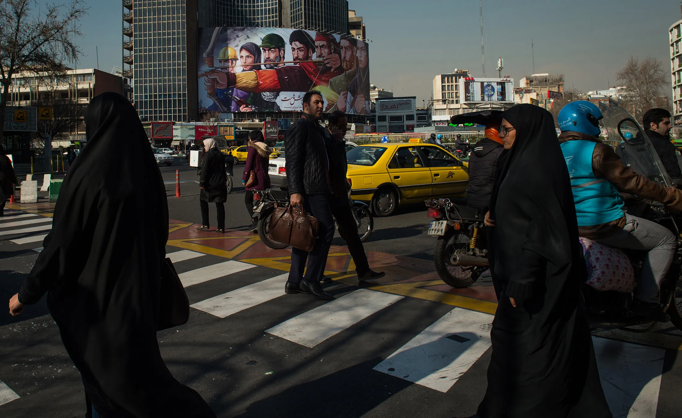 Pedestrians cross a street&nbsp;in Tehran.