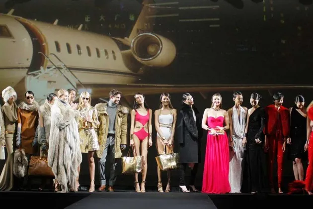 Models showcase designs during the Michael Kors 'Jet Set Experience' event on May 9 in Shanghai