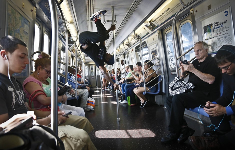A member of WAFFLE NYC performs on a train in 2014.