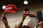 People wave hats and hold phones as Trump holds a rally with supporters in Aston, Pennsylvania, in September. 