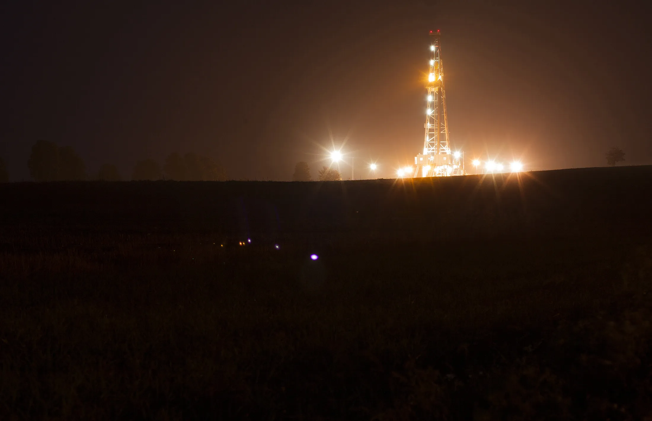 Light illuminates a shale gas drilling rig.