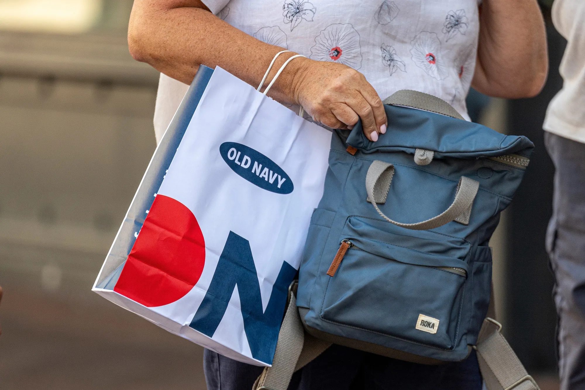 A customer carries an Old Navy shopping bag outside the company's store in San Francisco.