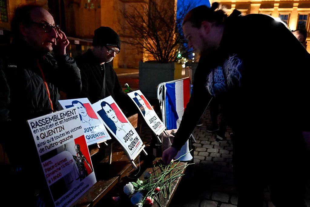 A demonstrator lays a flower during a rally to demand justice for the death of&nbsp;far-right activist Quentin&nbsp;Deranque.