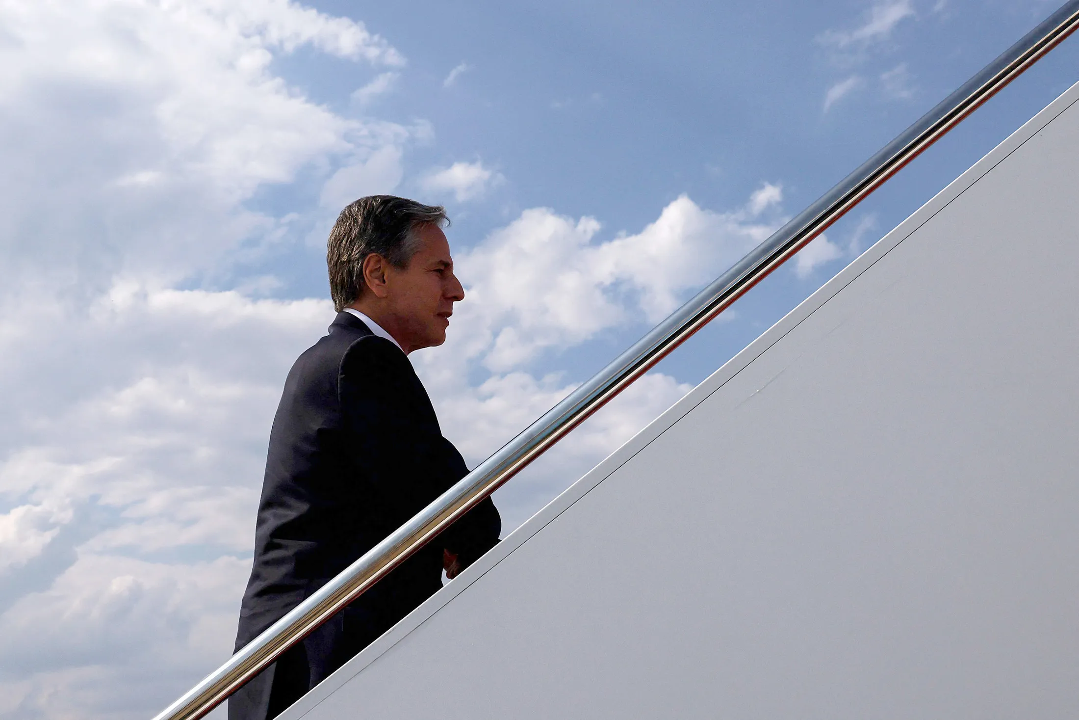 Antony Blinken boards an aircraft as he departs Washington, on July 26.