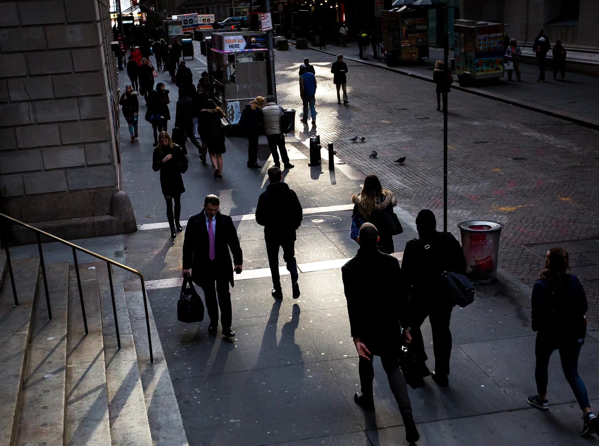 Pedestrians walk along Wall Street near the New York Stock Exchange.