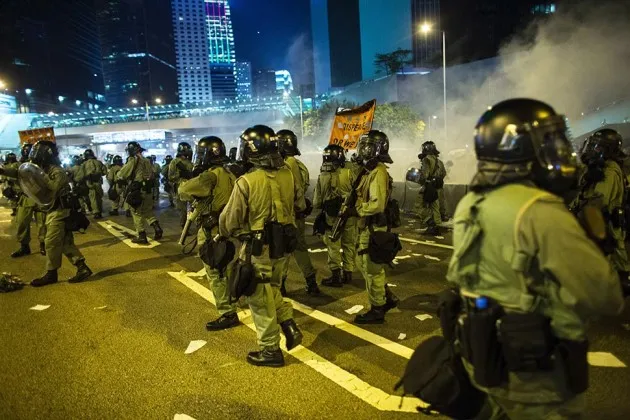 Riot police disperse demonstrators with tear gas during a protest near central government offices in Hong Kong on Sept. 28