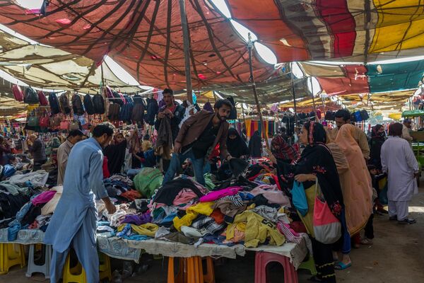 Shoppers browse clothing at a market in Karachi