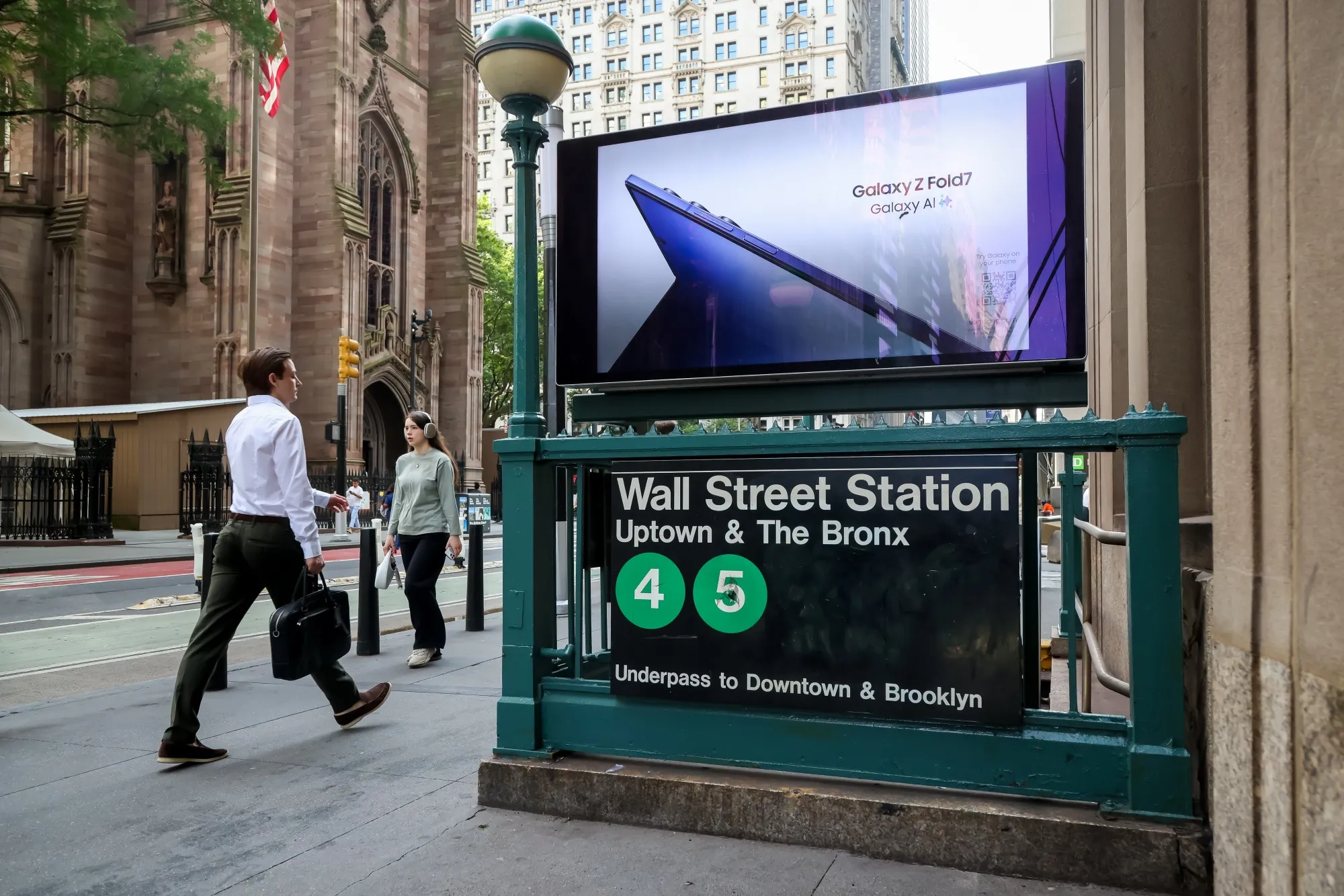 Commuters pass a Wall Street subway station near the New York Stock Exchange.