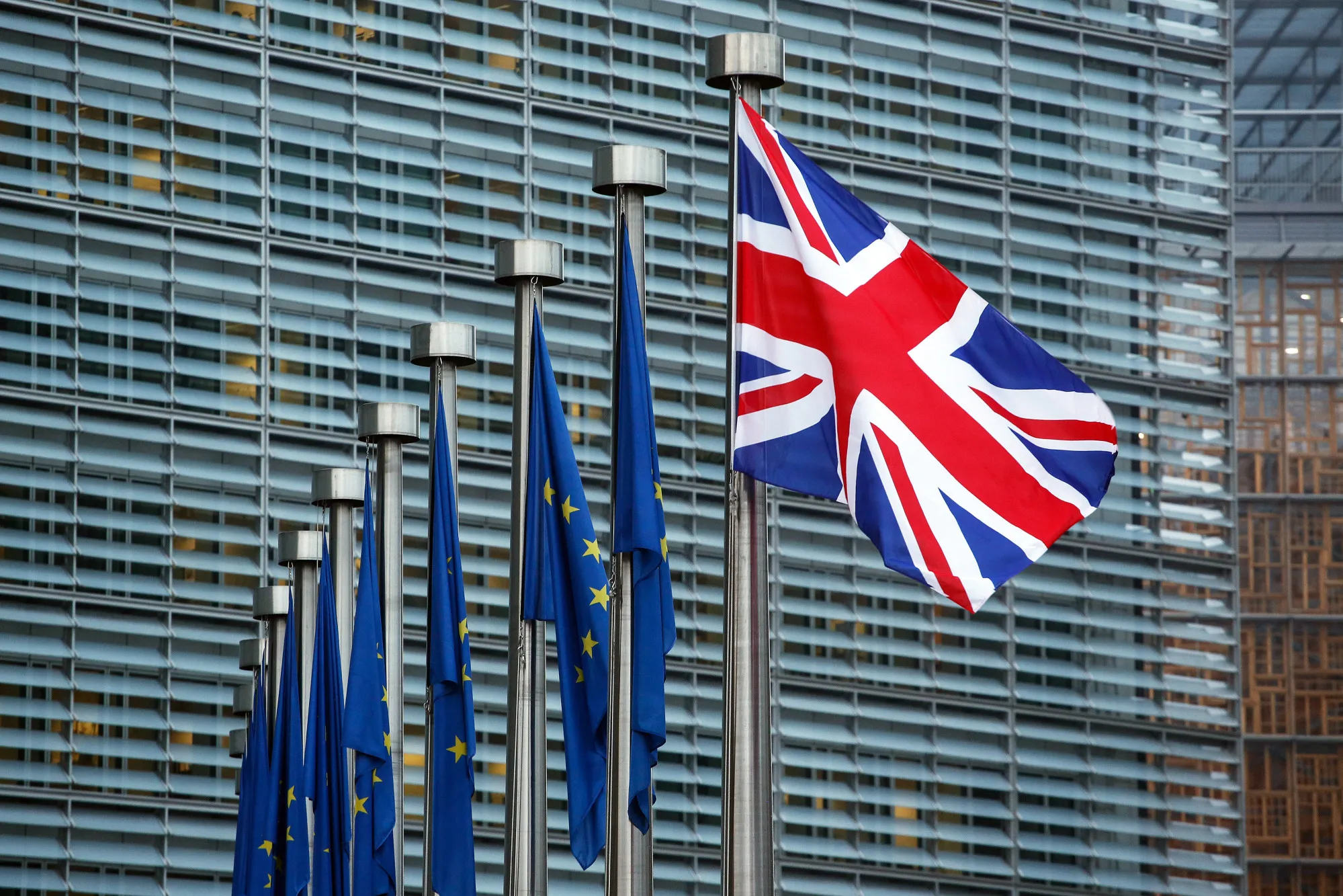 A UK flag&nbsp;flies next to European Union flags outside the European Commission in Brussels, Belgium.&nbsp;