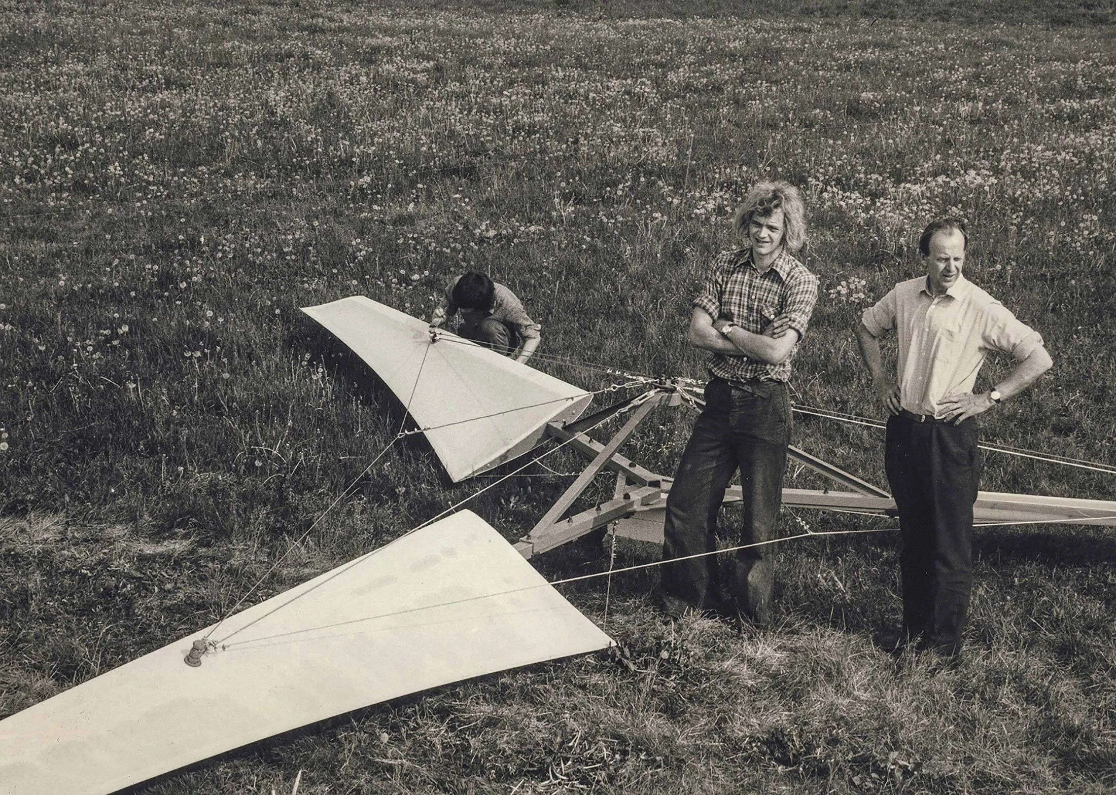 Henrik Stiesdal (center) stands with his father (right) during the construction of an early wind turbine in rural Denmark.