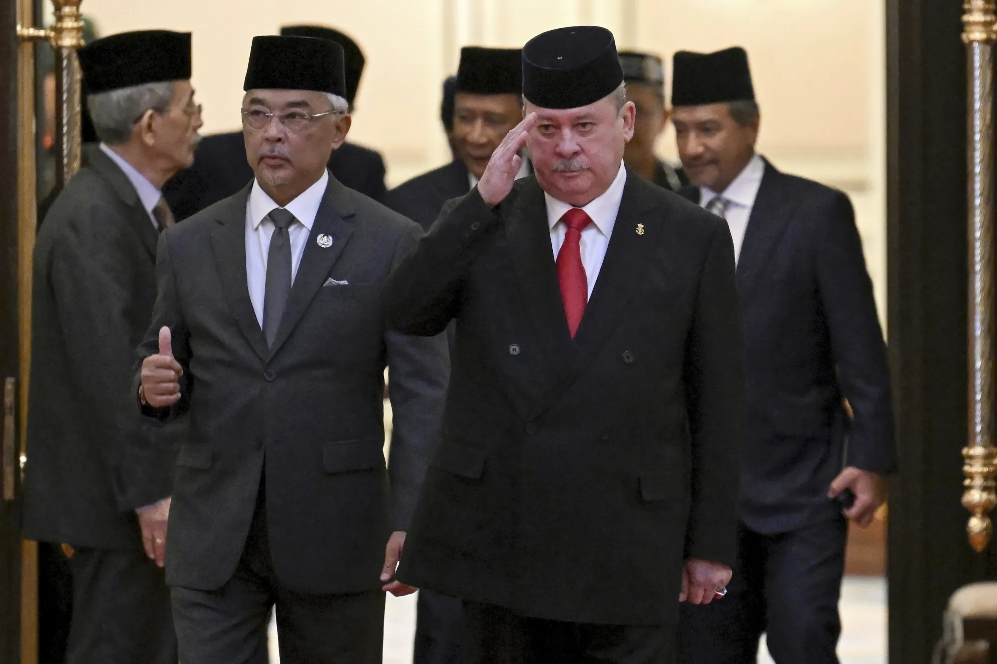 Sultan Ibrahim Sultan Iskandar, front right, walks with Malaysia’s King Sultan Abdullah Sultan Ahmad Shah, at the National Palace in Kuala Lumpur, on Oct. 27.