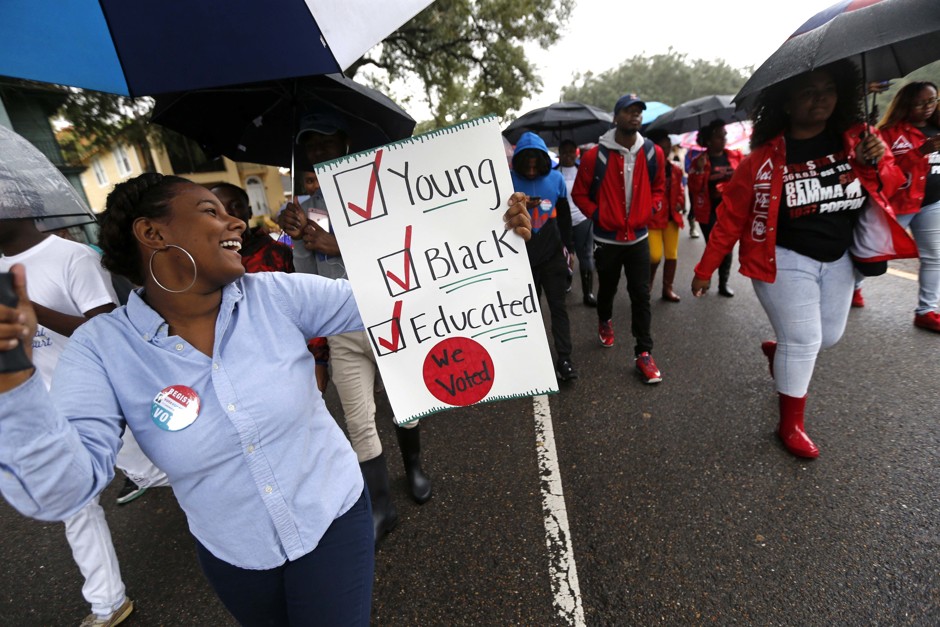Mariah Hickman, a Dillard University student, marches in unison with fellow students to a polling place to vote on election day in New Orleans, Tuesday, Nov. 8, 2016. 