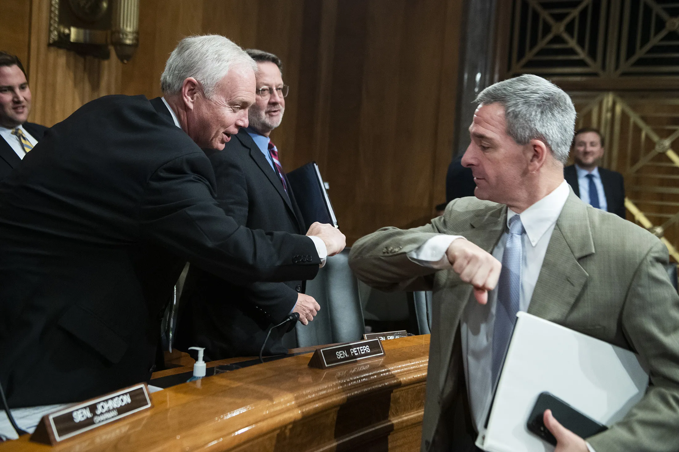 Ken Cuccinelli, acting deputy secretary for the Department of Homeland Security, right, elbow bumps Senator Ron Johnson, a Republican from Wisconsin, after testifying during the Senate Homeland Security and Governmental Affairs Committee hearing on&nbsp;March 5.