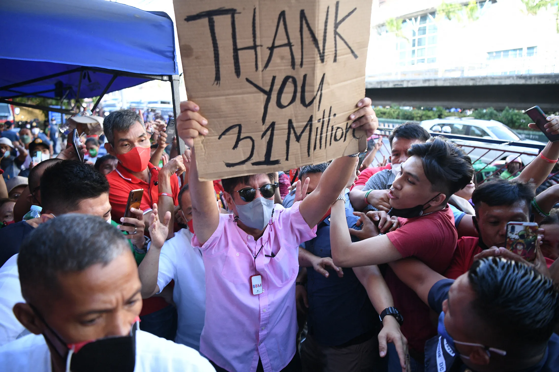 Ferdinand Marcos Jr., center, arrives at the campaign headquarters in Manila on May 11.