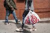 A shopper carries Target Corp. shopping bags while walking in New York.