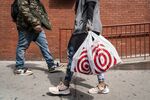 A shopper carries Target Corp. shopping bags while walking in New York.