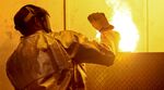 A casting technician takes the top off of a mold at an Alcoa castings plant in Hampton, Virginia.