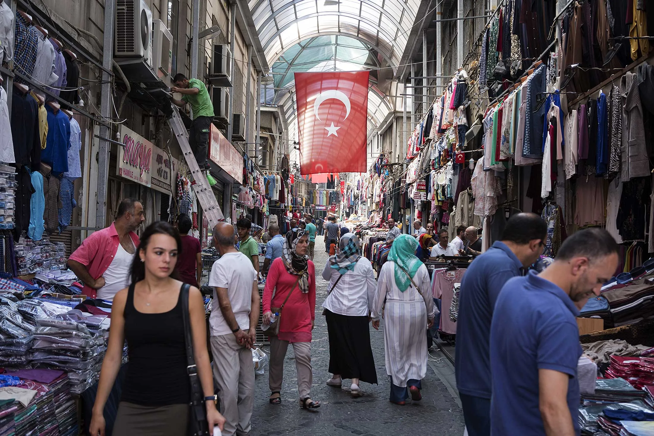 Customers browse clothes stores in an arcade in Istanbul.
