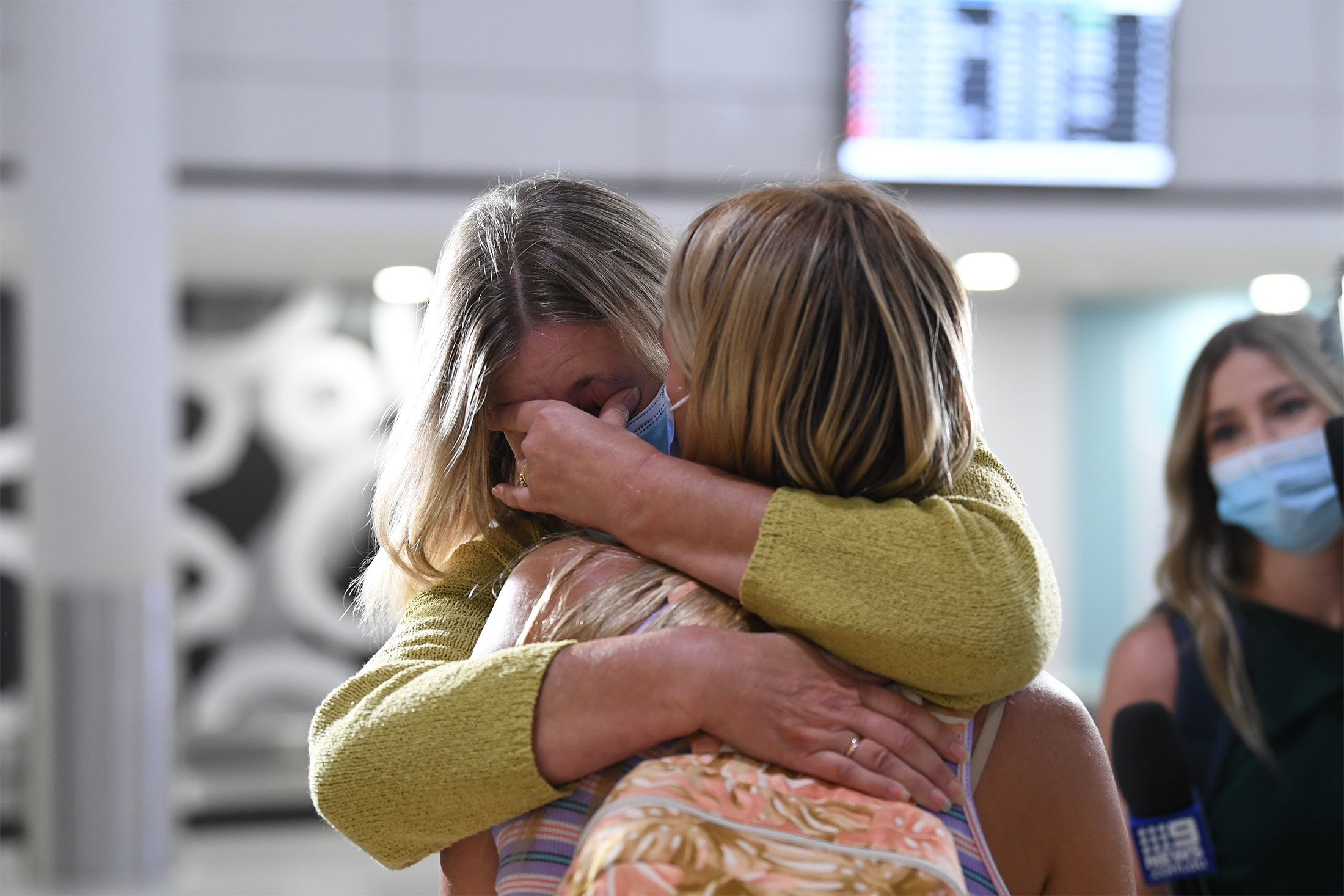 &nbsp;A mother hugs her daughter after she lands at Perth airport on the first domestic flight into Western Australia on March 3.