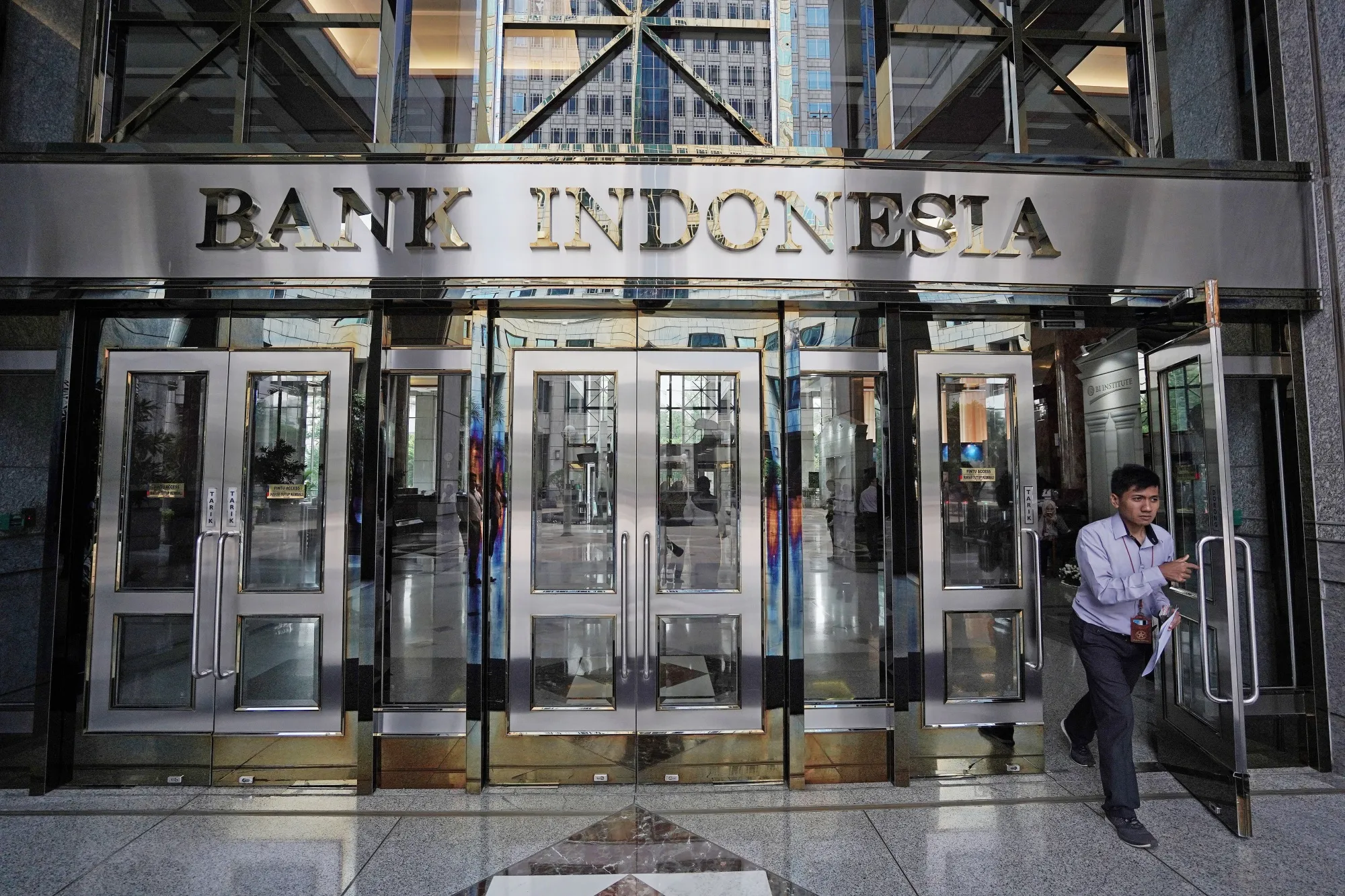 A man exits the Bank Indonesia headquarters in Jakarta, Indonesia.