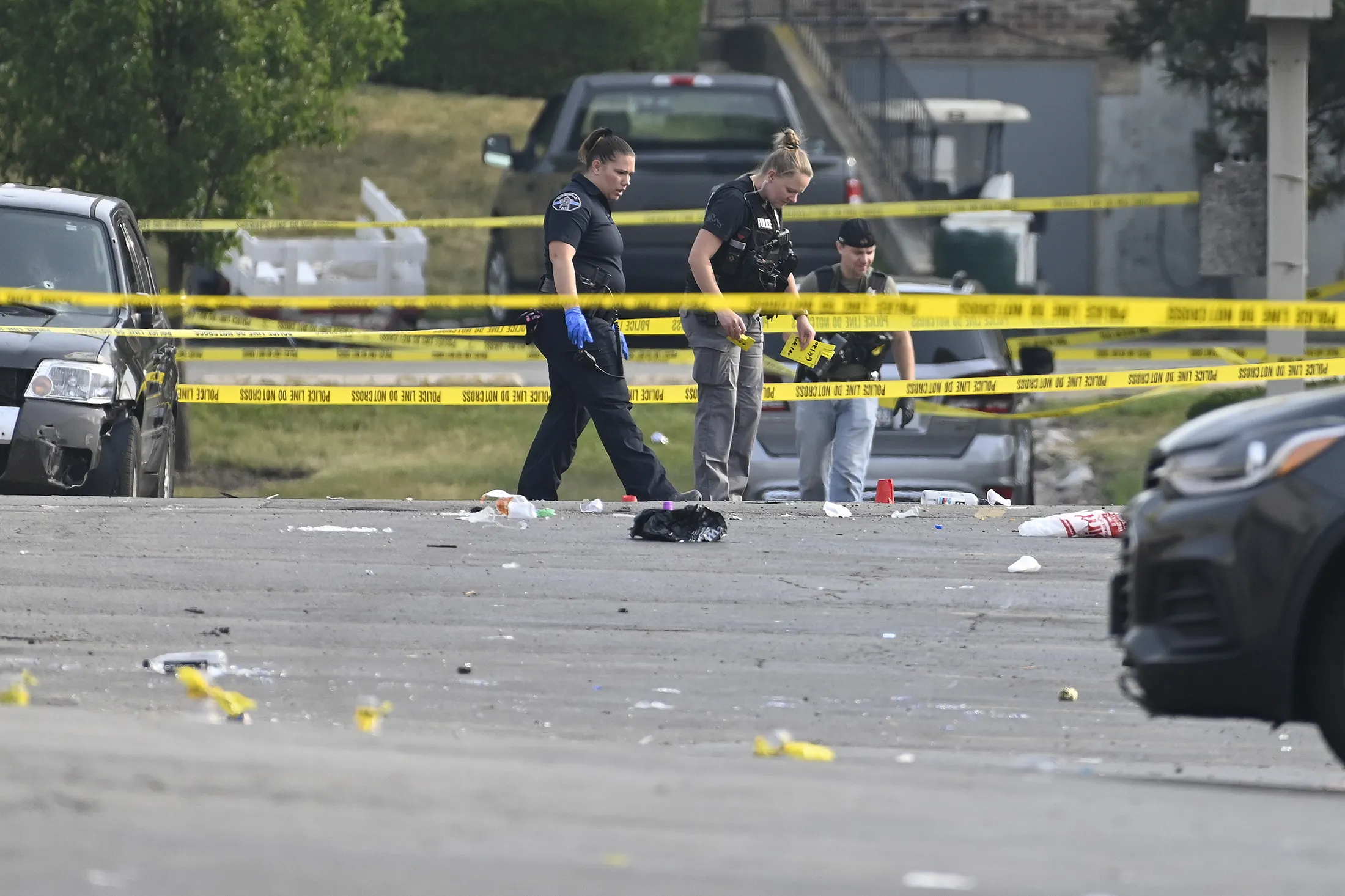 Investigators look over the scene of an overnight mass shooting at a strip mall in Willowbrook, Illinois, on&nbsp;June 18.