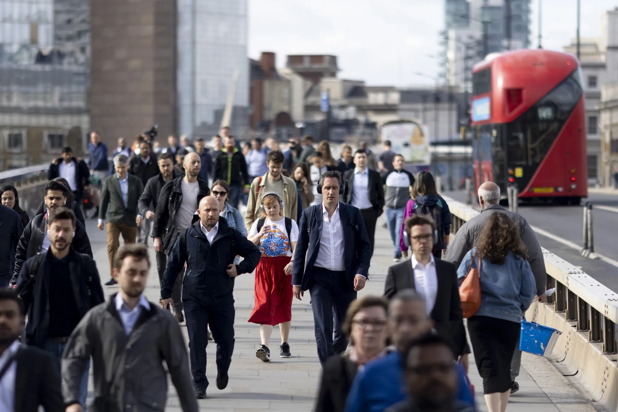 Morning commuters on London Bridge in the City of London, UK.