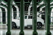 Unfinished automobiles are seen in a light tunnel used to detect imperfections at the Hyundai Metaplant .